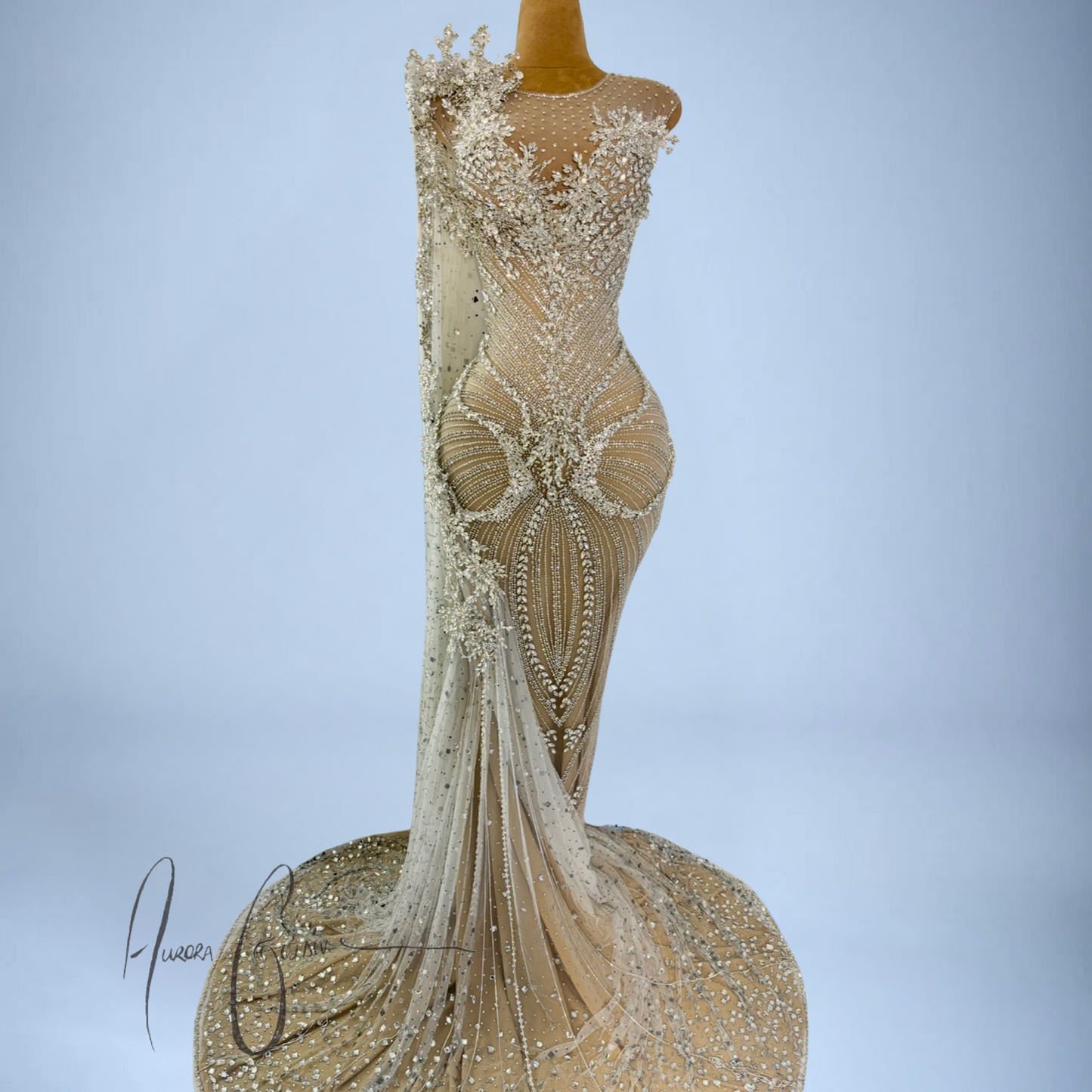 Aurienne mermaid silhouette showcasing intricate silver embellishments and flared crystal train