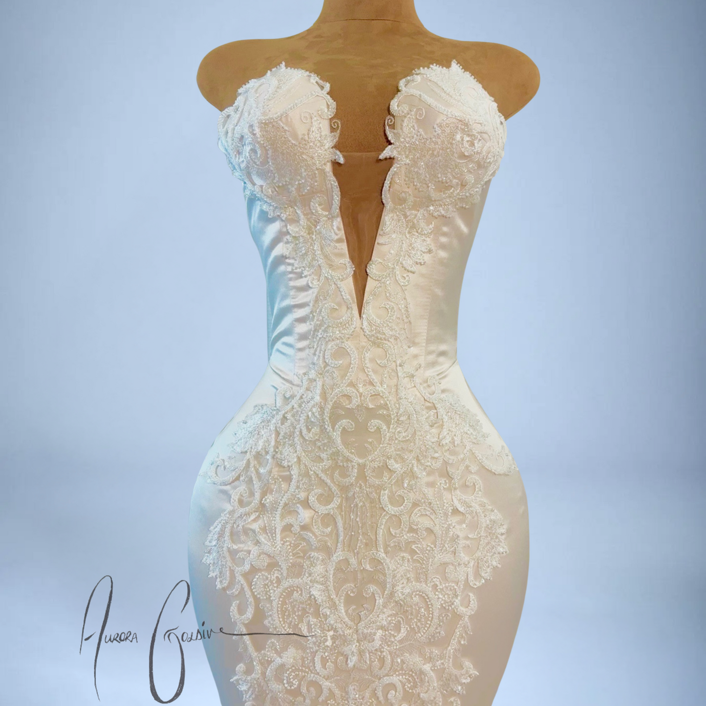 White lace dress on a mannequin against a light blue background