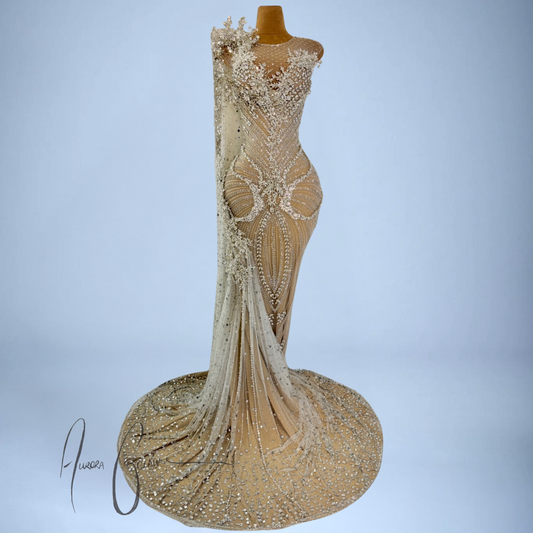 Aurienne couture gown with illusion one-shoulder neckline, silver 3D beadwork, and cascading rhinestone side train
