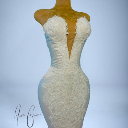 White lace dress on a mannequin against a light blue background