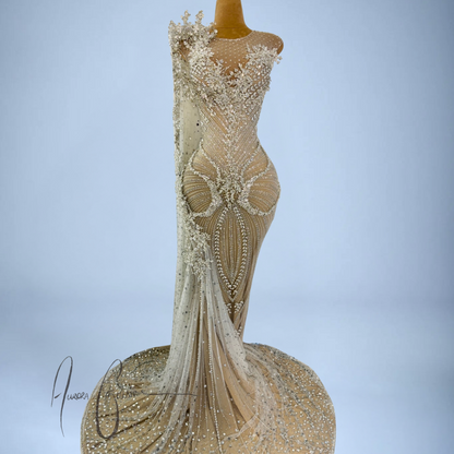 Aurienne mermaid silhouette showcasing intricate silver embellishments and flared crystal train